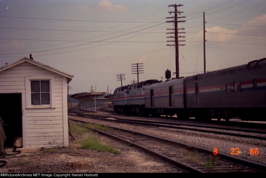 An Amtrak train arrives at the station on a clear signal